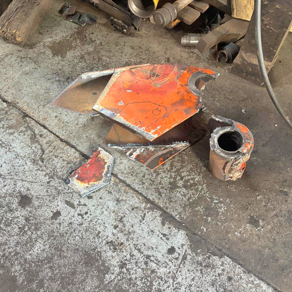 Crane boom before repair, damaged plating and pin boss cut out